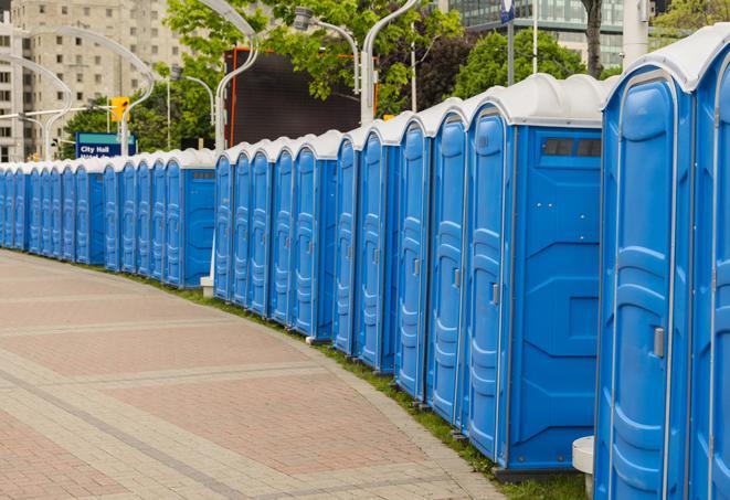 hygienic portable restrooms lined up at a music festival, providing comfort and convenience for attendees in Edmond OK